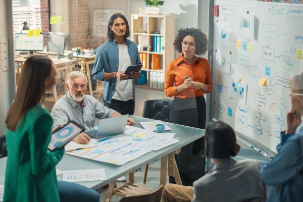 A diverse team of professionals engaged in a collaborative meeting in a modern office.