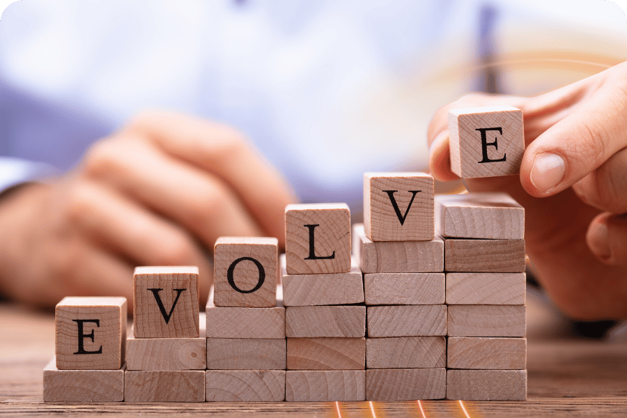 Wooden blocks stacked to spell “Evolve,” representing growth and continuous improvement within a Data 360 framework.