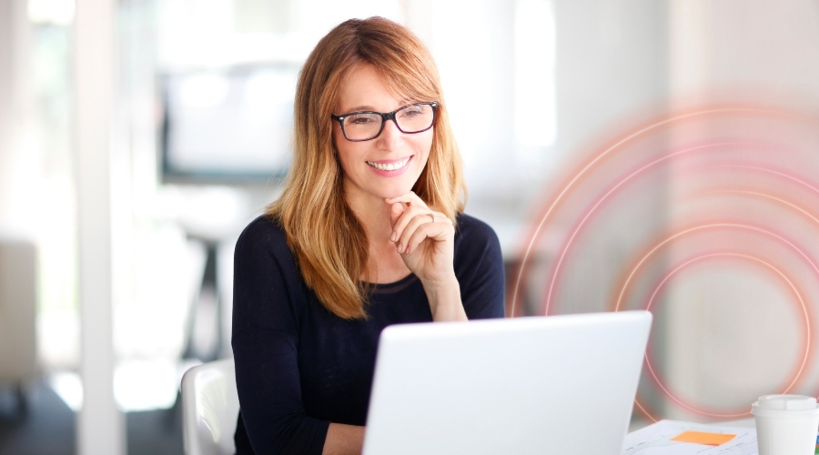 Professional working on a laptop in a modern office, representing focused delivery, digital solutions, and efficient project execution.