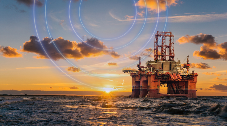 Oil rig in the ocean at sunset