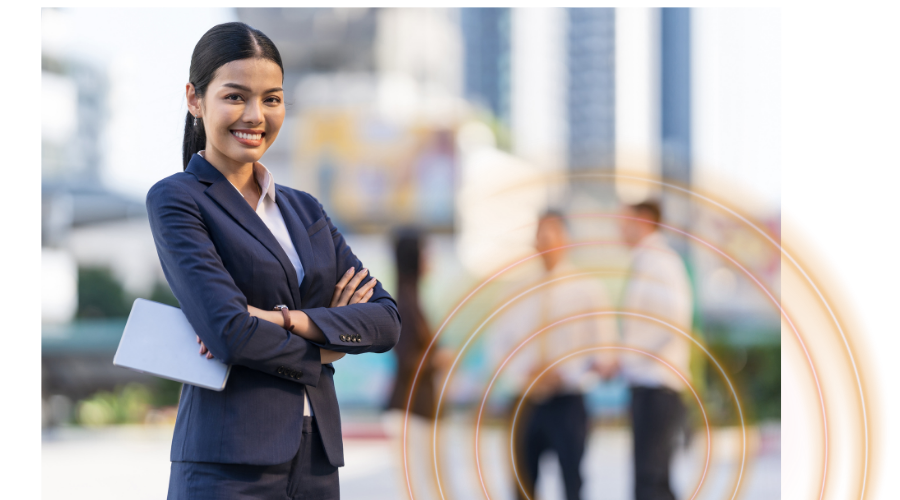 Business woman in the forefront and 2 people blurred in background