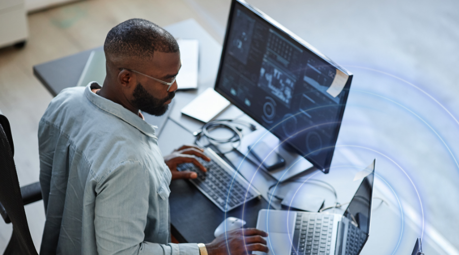 Man working on a computer with 2 screens